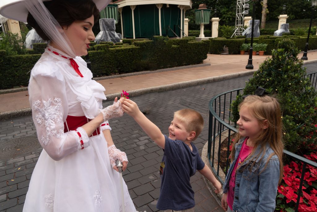 Discover the Magic of Finding Mary Poppins in the UK Pavilion at Epcot in Disney World 1 Mary Poppins character hands a flower to a delighted boy in the UK Pavilion at Epcot