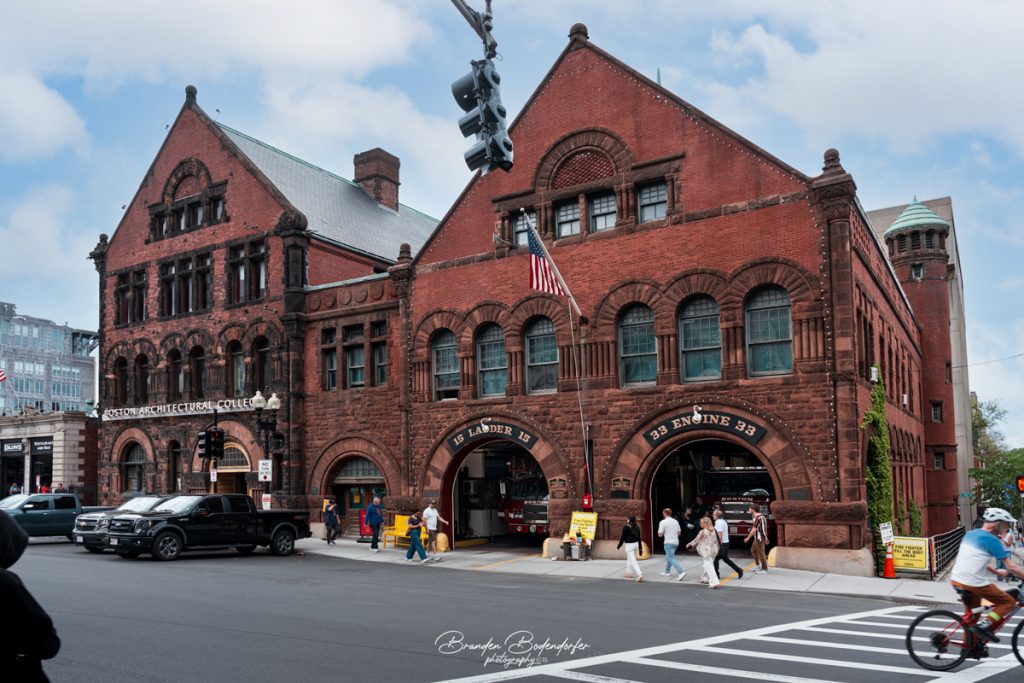 Boston Fire Station: Capturing the Heart of the City 1 Historic red brick Boston fire station housing Ladder 15 and Engine 33, with pedestrians crossing outside